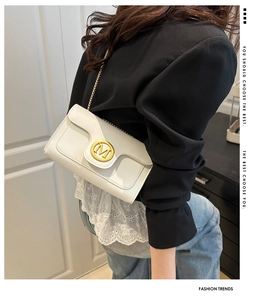 Chic white leather small square bag with golden M logo and chain strap shown on model