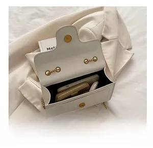 Interior view of white crossbody bag showing storage for phone, wallet and cosmetics