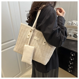 Detail of woven tote bag with cream leather trim and matching zip pouch hanging