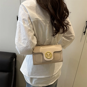 Beige quilted leather crossbody bag with gold chain strap and M letter hardware