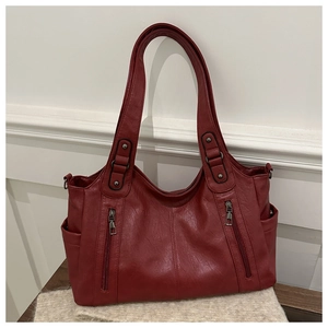 Close-up of the wine red leather tote bag showing symmetry zippers and soft texture