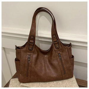 Detail view of brown vintage PU leather tote bag with functional vertical zipper pockets