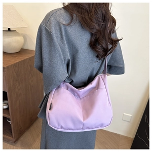 Detailed back view of a purple nylon hobo shoulder bag with stylish stitched patterns