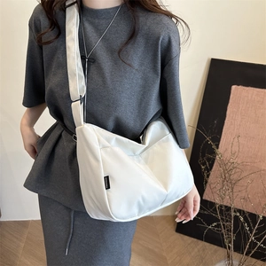 Minimalist white nylon crossbody bag with wide strap and large capacity for daily use