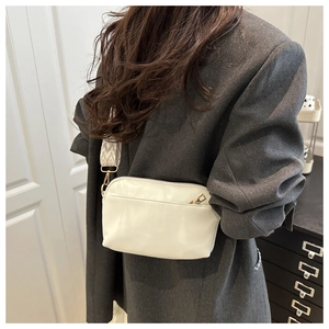 Chic cream white crossbody bag with ethnic pattern wide strap on grey blazer