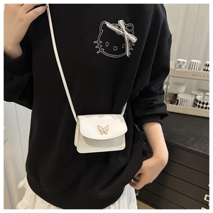 Detailed close-up of white mini square bag with golden butterfly clasp and PU leather texture