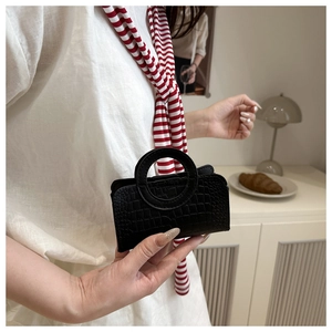 Mini black crocodile pattern handbag with a unique circular handle for a stylish look