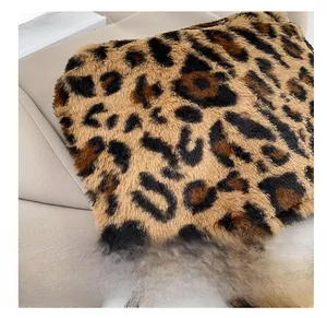 Close-up of leopard print faux fur texture on a stylish autumn shoulder bag detail