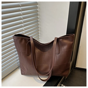 Detail view of dark brown PU tote bag with elegant crocodile pattern and smooth finish