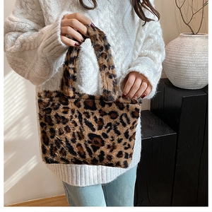 Detail of leopard print faux fur tote bag with plush texture and matching handles