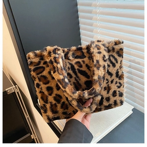 Close-up of leopard print plush tote bag with thick faux fur texture and handle
