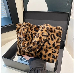 Detail of soft leopard print faux fur tote bag presented in a premium black gift box