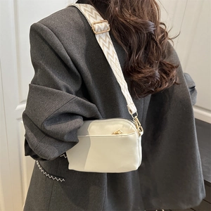 Minimalist beige small square crossbody bag with wide patterned woven shoulder strap