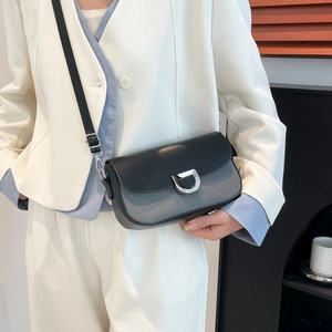 Minimalist black and grey contrast crossbody bag with silver D-ring buckle on model