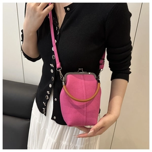 Detail of rose pink canvas crossbody bag with vintage metal frame and leather handle