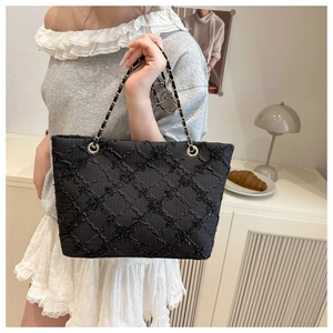 Dettaglio borsa shopper trapuntata nera con paillettes luccicanti e catena dorata