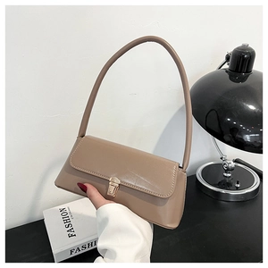 Close-up of the light coffee PU leather baguette bag featuring a gold rectangular metal buckle