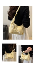 Detail of cream yellow crescent bag with pearl bow and lace ribbon decoration