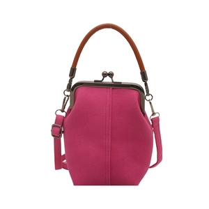 Magenta canvas crossbody bag with retro doctor bag frame and brown leather handle