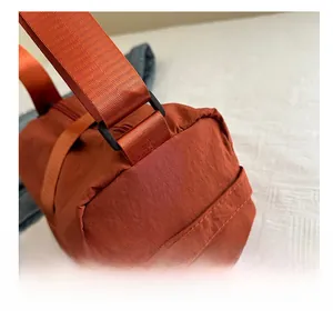 Detail shot of the durable orange oxford fabric texture and strap buckle connector