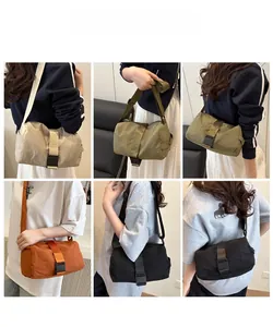 Detail showing various colors of cylindrical oxford fabric crossbody bags with buckles