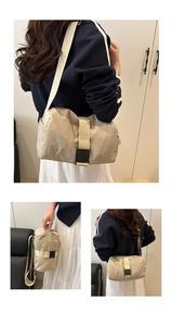 Detail view of beige nylon crossbody bag featuring large buckle and adjustable strap