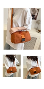 Detailed view of an orange oxford fabric toast bag with stylish buckle closure on a model