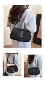 Detail of minimalist black nylon crossbody bag with adjustable strap and buckle closure