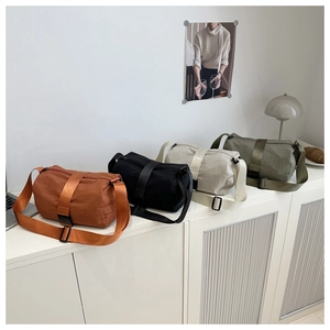 Row of waterproof oxford fabric crossbody bags in caramel, black, grey and olive green