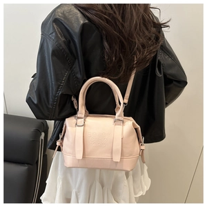 Detail of pink Boston bag with EOJOY CIHO 2AD embossing and detachable shoulder strap