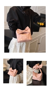 Detailed view of the pink bow handbag with silver chain strap and glossy finish