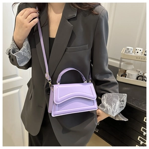 Detail view of lavender small square bag with wavy stitching and adjustable strap