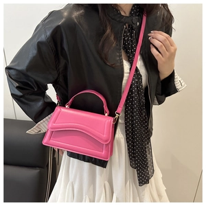 Detail of magenta PU leather handbag with gold-tone hardware and adjustable strap