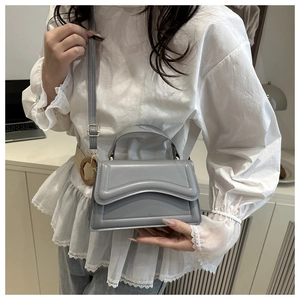 Gray structured crossbody bag with wavy quilting and light gold hardware detail