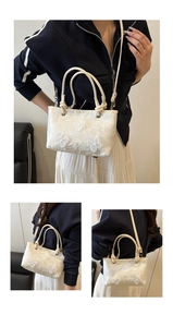 Macro detail of white lace butterfly embroidery on a textured bucket bag with rope handles