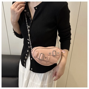 Détail du sac en forme de cœur rose avec boucles élégantes et bandoulière chaîne
