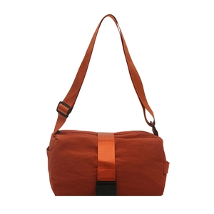Minimalist rust orange nylon oxford crossbody bag with adjustable strap and buckle