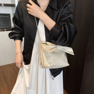 Chic cream tote bag with large bow and silver chain strap for women office style