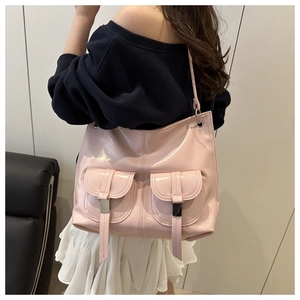 Detailed view of light pink patent leather tote bag with shiny finish and front double pockets
