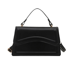 Minimalist black structured crossbody bag with elegant wavy stitching and gold hardware