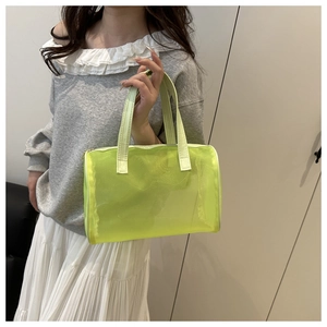 Close-up of translucent neon green mesh handbag with a zipper and top handle