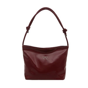 Minimalist large glossy burgundy shoulder bag with silver metal bow and knotted straps