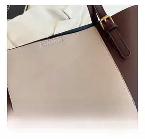 Detail view of contrast color faux leather tote with golden fashion lettering
