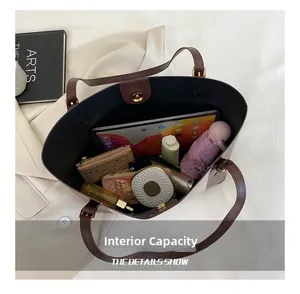 Macro shot of spacious tote bag interior showing capacity for tablet, umbrella and makeup