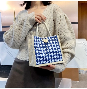Detail of blue houndstooth tote bag featuring rope handles and rustic linen side panels