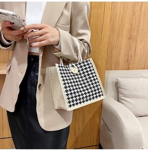 Detail of houndstooth tote bag with linen side panels and natural rope handles