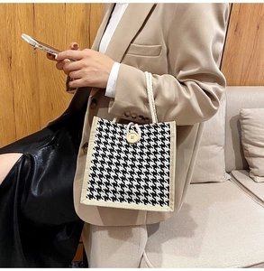 Close-up of houndstooth canvas tote bag with cotton rope handle and wooden button