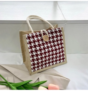 Detail of red houndstooth fabric pattern and jute texture on this large tote bag