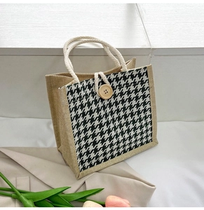 Close-up of houndstooth tote bag featuring woven texture and cotton rope handles