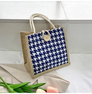 Detail of blue houndstooth canvas tote bag with thick cotton rope handles and wood button